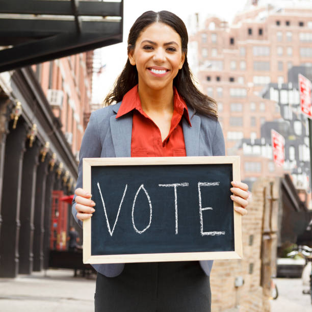 istock Woman With VOTE Sign 1398490565