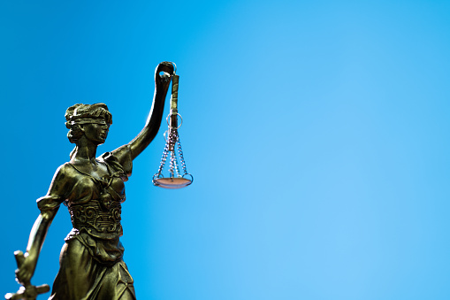 Lady justice on blue background.