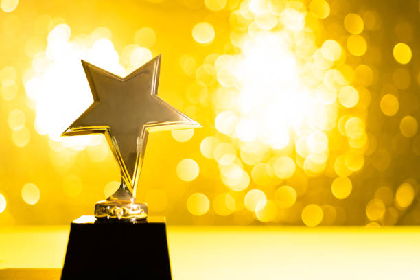 Star trophy on shiny yellow background