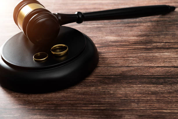 istock Wedding rings and gavel on wooden table 1398491762