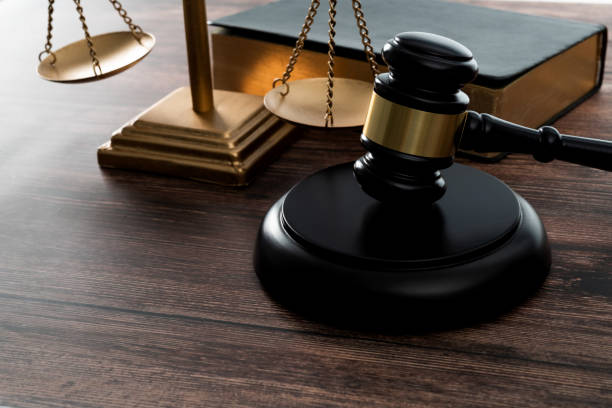 Gavel and scales of justice on the table stock photo