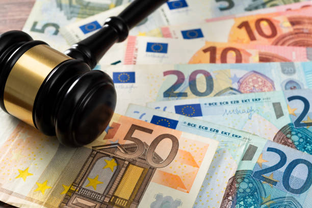 Gavel and stack European Union currency on the table stock photo