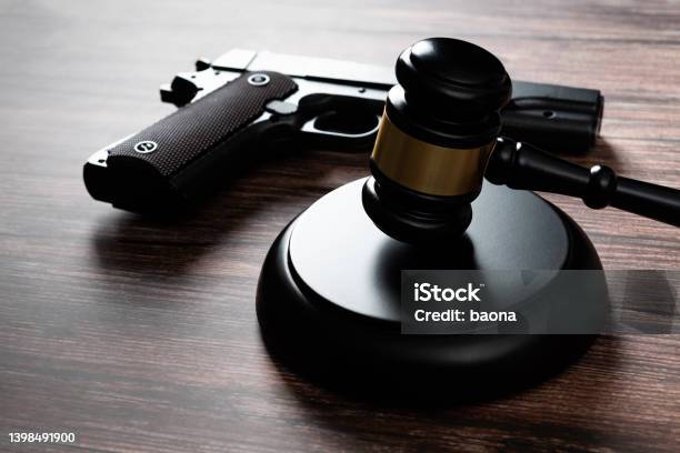 Gun And Gavel On The Table Stock Photo - Download Image Now - Gun, Law, Legal Defense