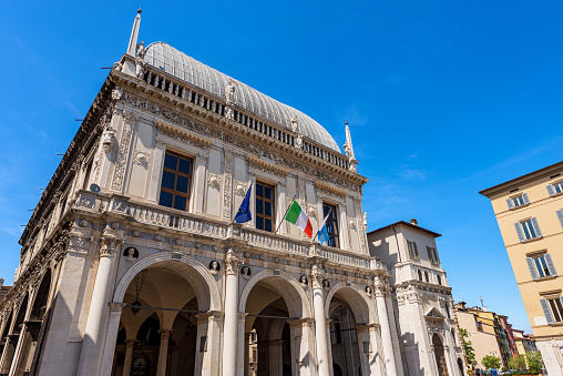 Brescia, Italy - April 17, 2022: Brescia downtown. Ancient Loggia Palace (Palazzo della Loggia) in Renaissance Style, 1492-1574, in Loggia town square (Piazza della Loggia). Lombardy, Italy, Southern Europe.