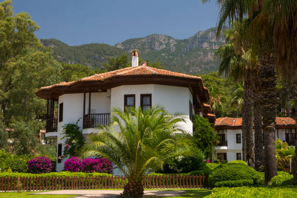 MUGLA / Turkey - June 25, 2021: White duplex summer house, blue sky in the background. Traditional Muğla houses. Horizontal close-up.