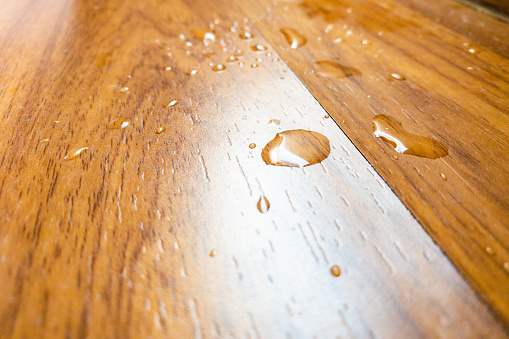 water spill on parquet wood floor, which leaking from air conditioner in the house.