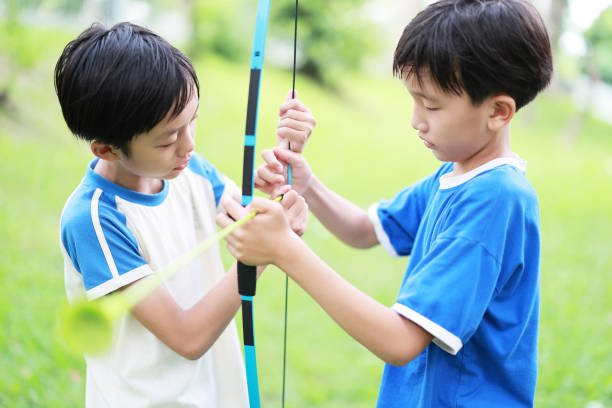 istock Little boy shoots bow in the park 1398497771