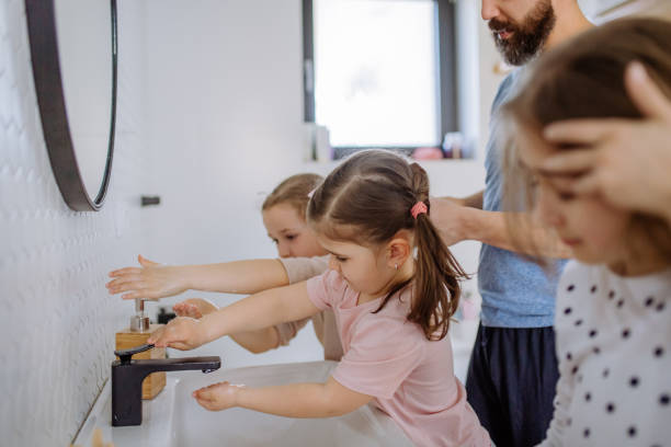 istock Father with three little children in bathroom, morning routine concept. 1398500342