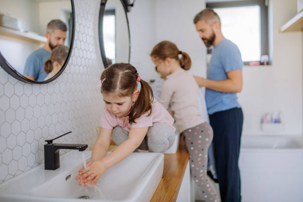 istock Father with three little children in bathroom, morning routine concept. 1398500375