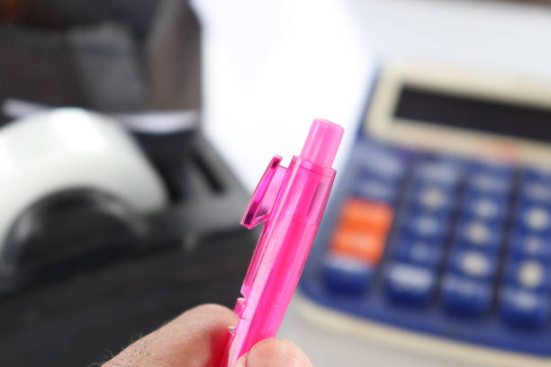 broken pink pen and office supplies background, old pan