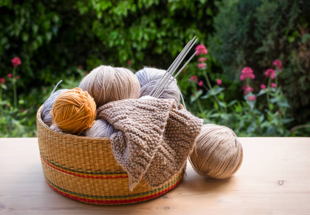 istock Knitting and knitting needles on a wooden surface. 1398504693