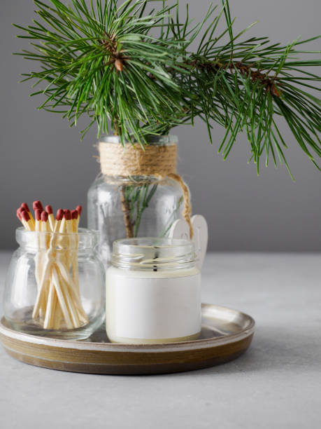 istock Burning candles and green branches on grey table, space for text 1398507457