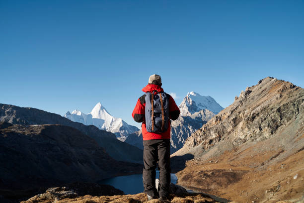 asian man backpacker male hiker looking at mountains in yading national park, china - backpack one mature man only only mature men one man only imagens e fotografias de stock