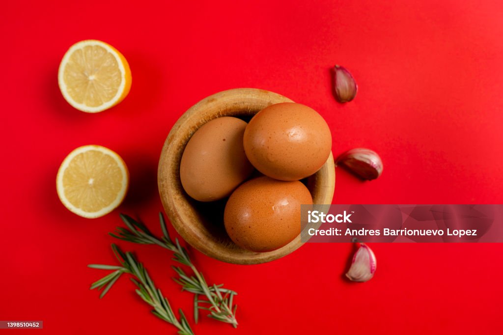 Top view of eggs, lemons and garlic ingredients needed to make the rich homemade alioli sauce typical Spanish sauce Top view of eggs, lemons and garlic ingredients needed to make the rich homemade alioli sauce typical Spanish sauce. Aioli Stock Photo
