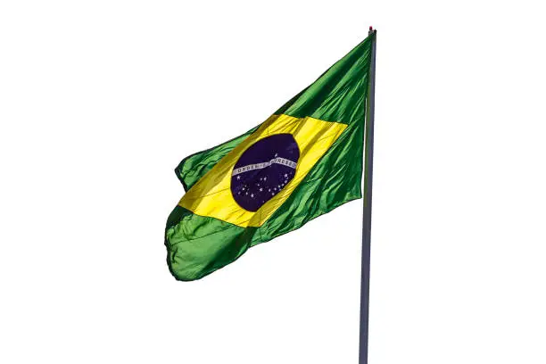 Goiania, Goiás, Brazil – May 19, 2022:  Brazil's flag. A Brazilian flag waving in the wind with a white background.