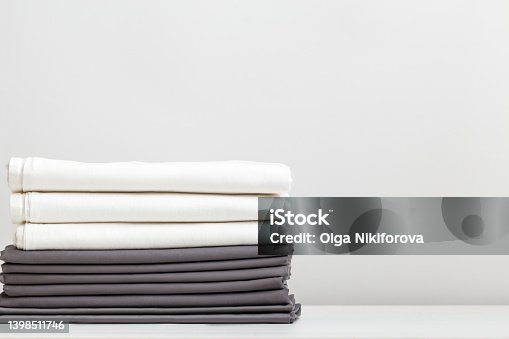 istock A stack of gray and white bed linens, sheets on the table. 1398511746
