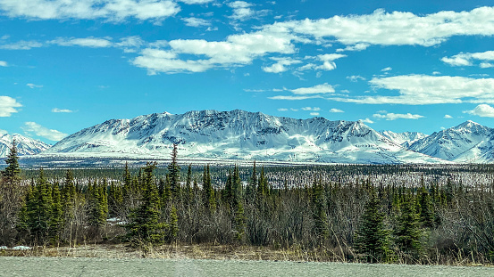 The mountains of Alaska begin to shed their winter snow and put on their new growth. Traveling through Alaska, visitors will see many beautiful scenes such as this. Alaska is a state full of many scenic opportunities.