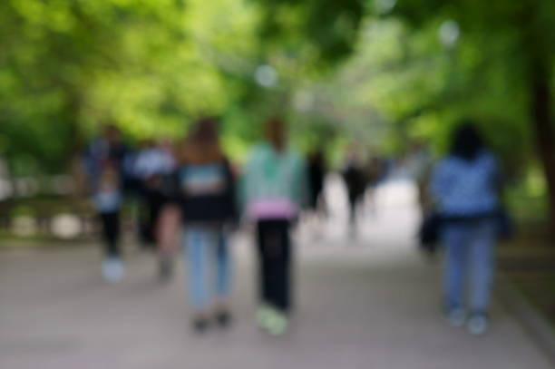 istock Blurred background. People in a public city park. 1398512906