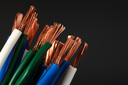 Electrical wires on black background, closeup. Space for text