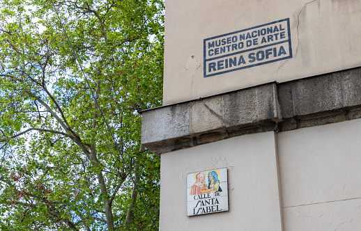 Madrid, Spain - April 23, 2022: A picture of the Museo Nacional Centro de Arte Reina Sofía sign and the Calle de Santa Isabel street sign.
