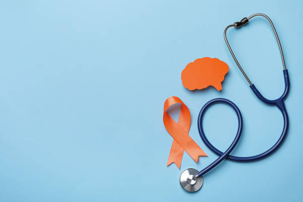 orange ribbon, stethoscope and paper brain cutout on light blue background, flat lay with space for text. multiple sclerosis awareness - esclerose múltipla imagens e fotografias de stock