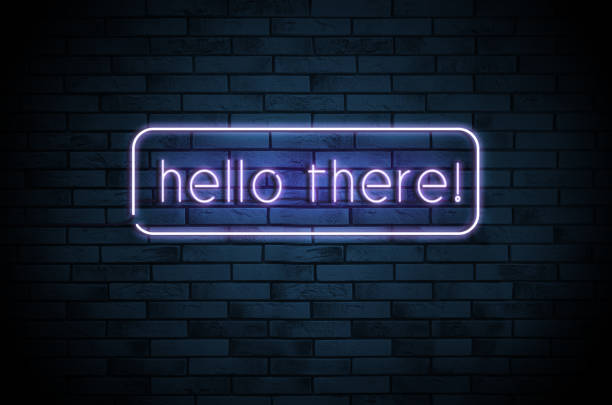 istock Stylish neon sign with phrase Hello there on brick wall 1398514785