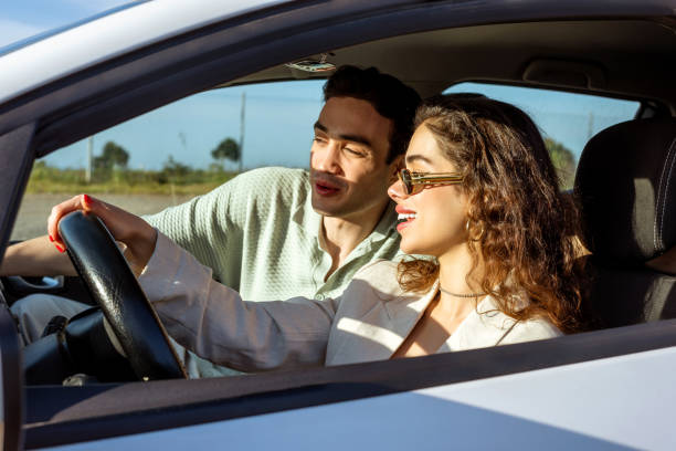 istock Young couple having fun trip on vacation road. 1398514795