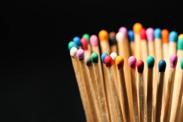 Matches with colorful heads on black background, closeup. Space for text