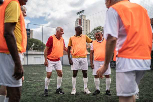 istock Senior men talking on the soccer field 1398520596