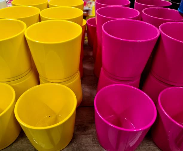 istock A stack of decorative yellow and pink flower pots. 1398520734