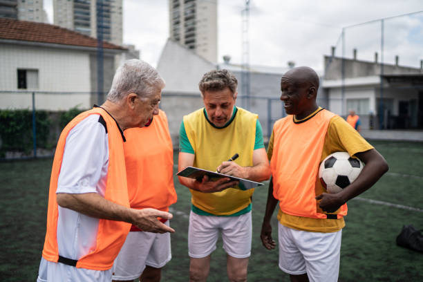 istock Coach discussing play strategy with the team on the soccer field 1398520829