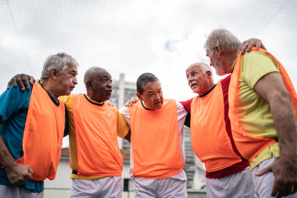 istock Senior men huddling before a match on the soccer field 1398520853