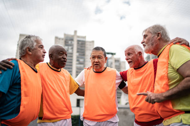 istock Senior men huddling before a match on the soccer field 1398520869