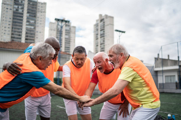istock Senior men with stacked hands on the soccer field 1398521535