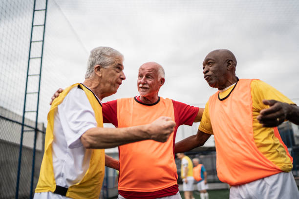 istock Senior men talking on the soccer field 1398521592