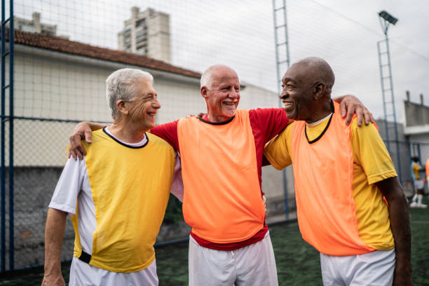 istock Senior men embracing on the soccer field 1398521600