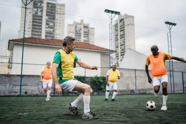 Mature men playing on the soccer field