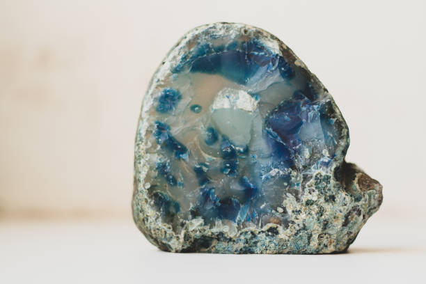 istock Large blue crystal of agate cross section isolated on white background. Natural translucent surface of agate crystal, blue abstract structural fragment 1398521627