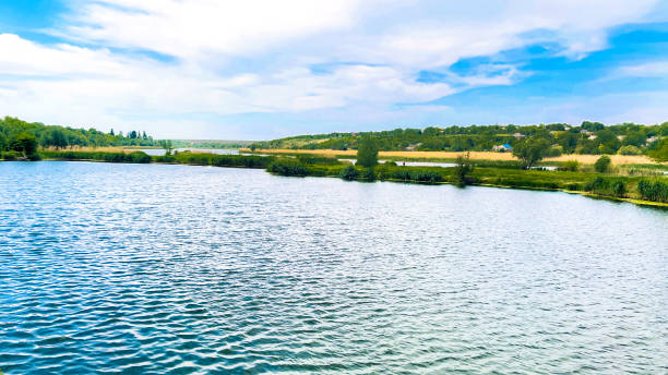 istock Ukraine.  Quarry filled with water and river in background.  Beautiful background image. 1398525297