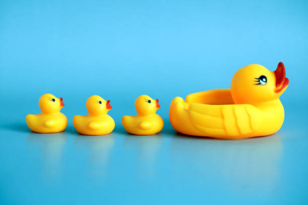istock rubber duck with ducklings on a blue background. 1398525889
