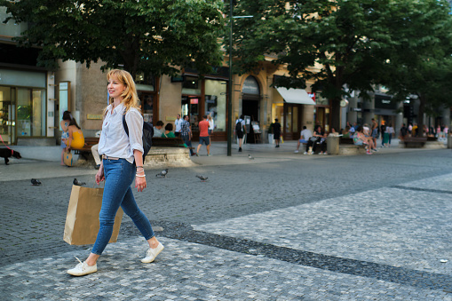 Shot during golden hour with a focus on capturing relaxed atmosphere on one of the main Prague's shopping streets.