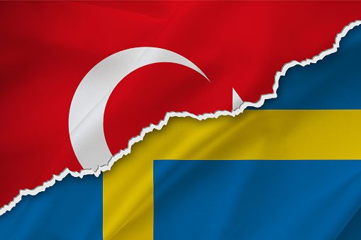 Turkey and Sweden waving silk flag ripped paper background.