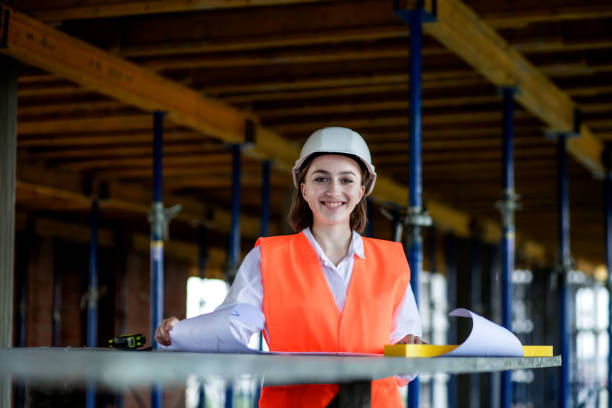 istock Architect or engineer working, browsing building project indoor of construction site with blueprint plan. Woman construction engineers or architects working people 1398540125