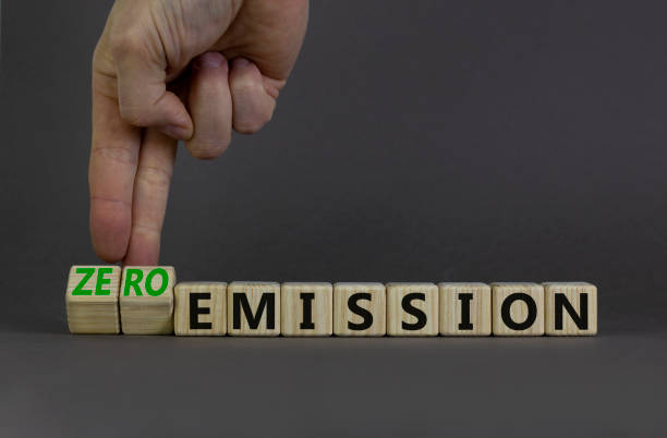 istock Zero emission symbol. Businessman turns wooden cubes and changes words Emission to Zero emission. Beautiful grey background. Business, ecological and zero emission concept. Copy space. 1398541116