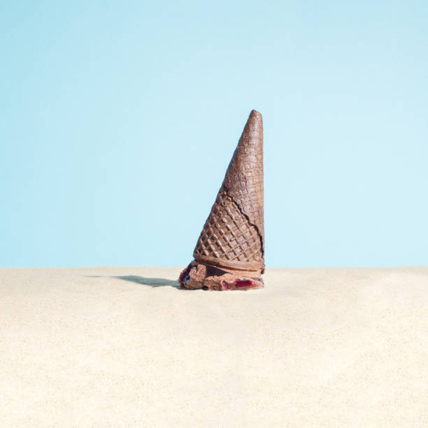 istock Melted chocolate ice cream in the beach sand.  Summertime. Vacation summer concept. 1398544710
