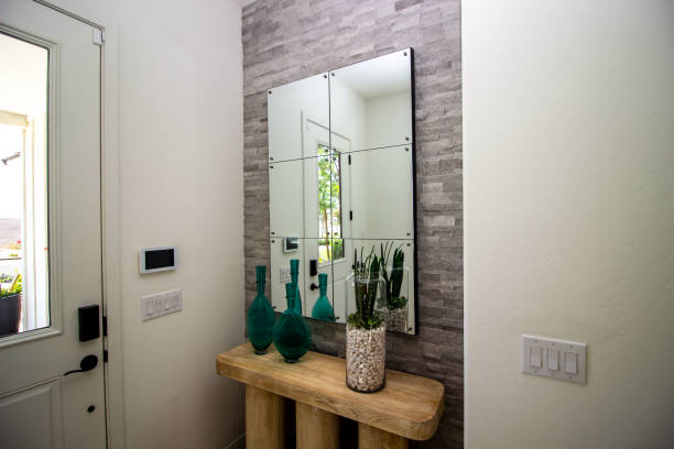 Entry Hallway With Mirror And Decorator Items On Wooden Table