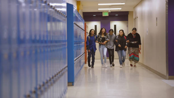 istock Five school kids walking through school corridor 1398547016