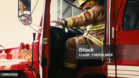 istock Firefighter about to close the door of his truck 1398547026
