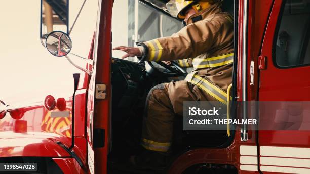 Firefighter About To Close The Door Of His Truck Stock Photo - Download Image Now - Firefighter, Fire Engine, Fire Station