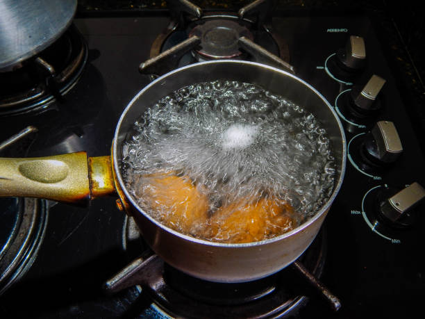 boiling eggs in a pot on the stove